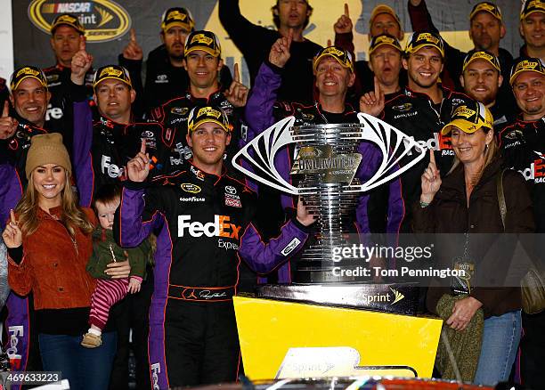 Denny Hamlin, driver of the FedEx Express Toyota, celebrates in Victory Lane with Jordan Fish and daughter Taylor during the NASCAR Sprint Cup Series...