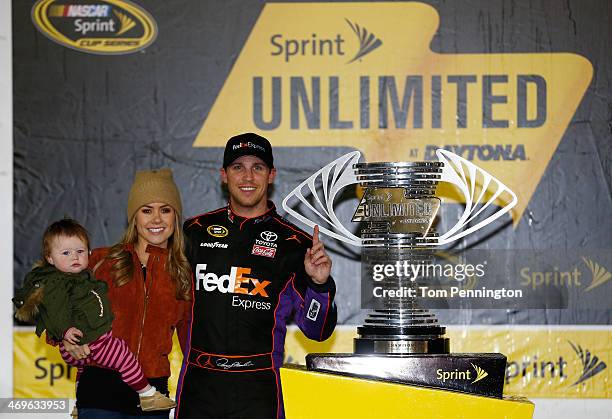 Denny Hamlin, driver of the FedEx Express Toyota, celebrates in victory lane with Jordan Fish and daughter Taylor during the NASCAR Sprint Cup Series...