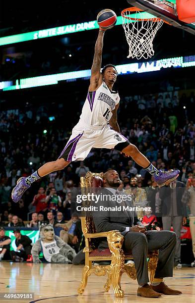 Western Conference All-Star Ben McLemore of the Sacramento Kings dunks the ball over Shaquille O'Neal during the Sprite Slam Dunk Contest 2014 as...