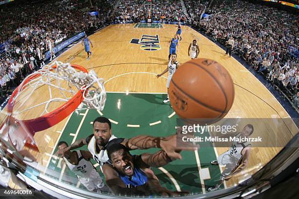 Bernard James of the Dallas Mavericks shoots the ball against Trevor Booker of the Utah Jazz on April 13, 2015 at EnergySolutions Arena in Salt Lake...