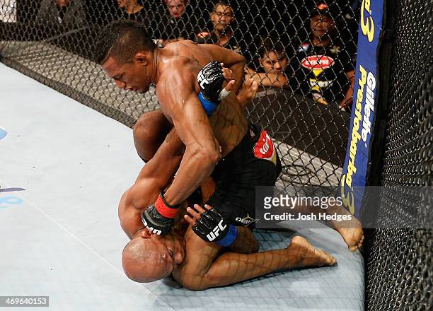 Yuri Alcantara punches Wilson Reis in their bantamweight fight during the UFC Fight Night event at Arena Jaragua on February 15, 2014 in Jaragua do...