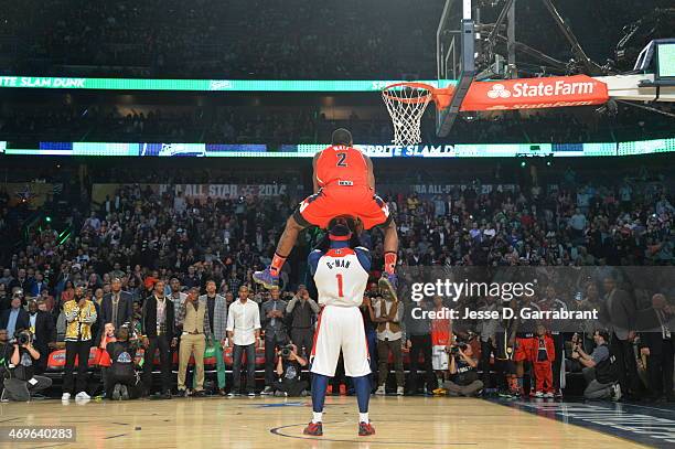 John Wall of the Washington Wizards dunks over the Wizards mascot during the Sprite Slam Dunk Contest on State Farm All-Star Saturday Night as part...