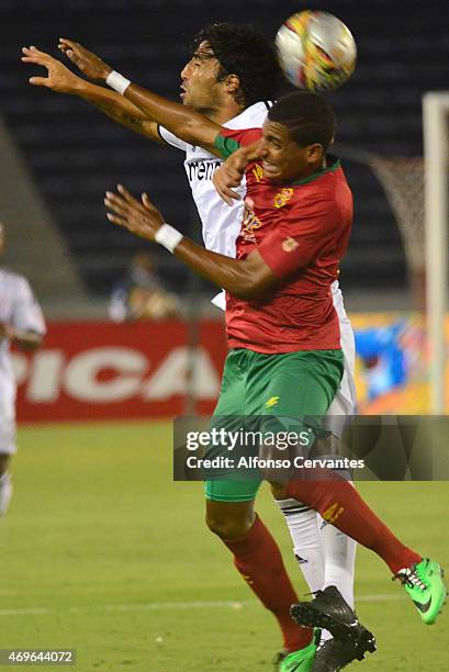 Gabriel Fuentes of Barranquilla and Ernesto Farias of America de Cali fight to head the ball during a match between Barranquilla FC and America de...