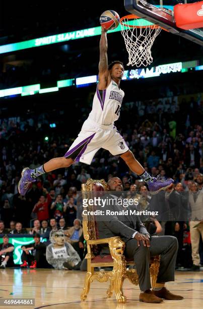 Western Conference All-Star Ben McLemore of the Sacramento Kings dunks the ball over Shaquille O'Neal during the Sprite Slam Dunk Contest 2014 as...