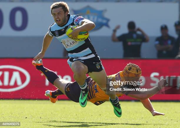 Nathan Gardner of the Sharks beats the tackle of Todd Lowrie of the Broncos during the match between the Sharks and the Broncos in the Auckland NRL...
