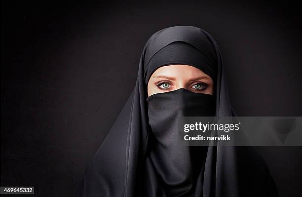 muslim woman with traditional black veil - burqa 個照片及圖片檔