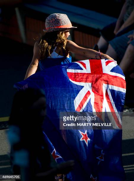 Young girl runs with the New Zealand flag during day 3 of the 2nd International Test cricket match between New Zealand and India in Wellington at the...