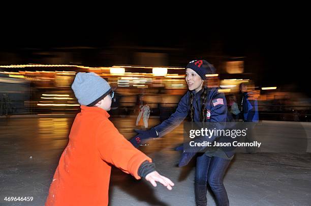 Olympian Tai Babilonia helps Ian Milstein of New York, New York skate on the Solaris Square ice skating rink during the USOC's Team USA Club Night at...