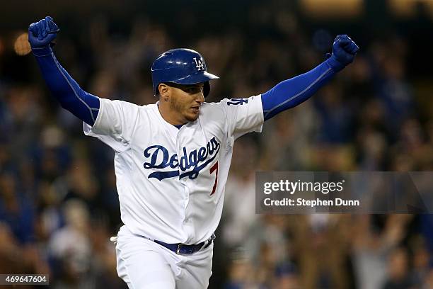 Alex Guerrero of the Los Angeles Dodgers celebrates as he runs to first after hitting a game winning walk off RBI single in the 10th inning against...