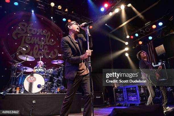 Drummer Eric Kretz, singer Chester Bennington and guitarist Dean DeLeo of Stone Temple Pilots perform onstage at House of Blues Sunset Strip on April...