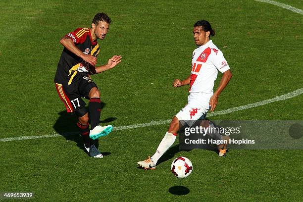 Vince Lia of the Phoenix passes around the defence of David Williams of the Heart during the round 19 A-League match between Wellington Phoenix and...