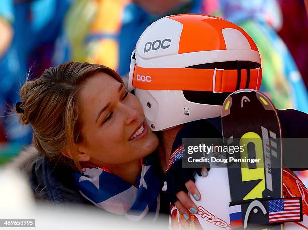 Morgan Miller greets her husband Bode Miller of the United States at the finish during the Alpine Skiing Men's Super-G on day 9 of the Sochi 2014...