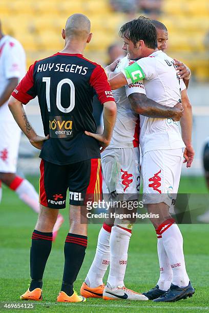 Patrick Kisnorbo and Rob Wielaert of the Heart congratulate each other after the final whistle while Stein Huysegems of the Phoenix looks on during...