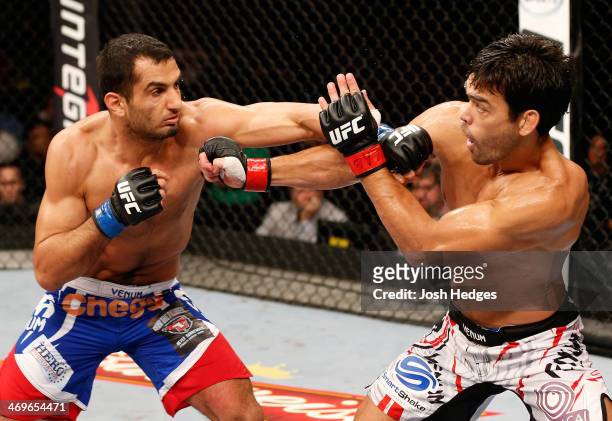 Gegard Mousasi punches Lyoto Machida in their middleweight fight during the UFC Fight Night event at Arena Jaragua on February 15, 2014 in Jaragua do...