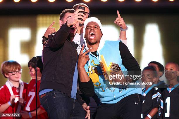 Player Joseph Fauria of the Detroit Lions accepts the Dance Machine award from co-hosts Colin Kaepernick and Cam Newton onstage during the 4th Annual...