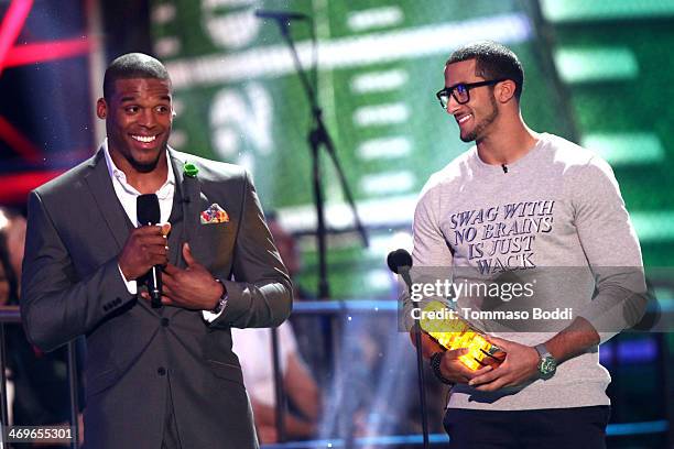 Co-hosts Cam Newton and Colin Kaepernick speak onstage during the 4th Annual Cartoon Network Hall Of Game Awards held at the Barker Hangar on...