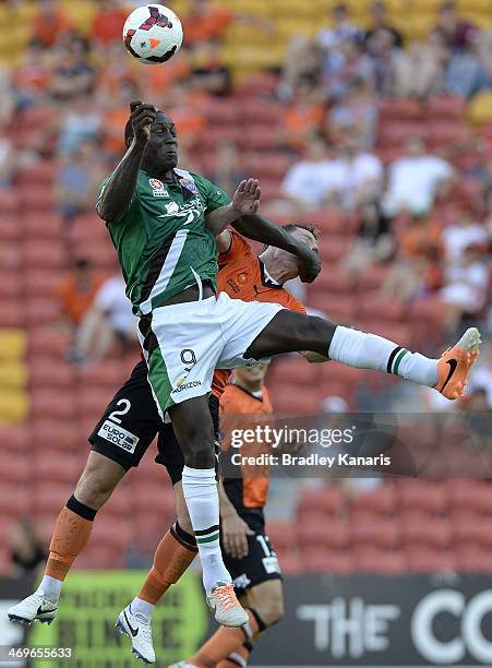 Emile Heskey of the Jets and Matthew Smith of the Roar challenge for the ball during the round 19 A-League match between Brisbane Roar and the...