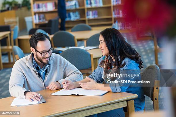 hispanic männliche und weibliche erwachsene studenten studieren in der bibliothek - male student wearing glasses with friends stock-fotos und bilder