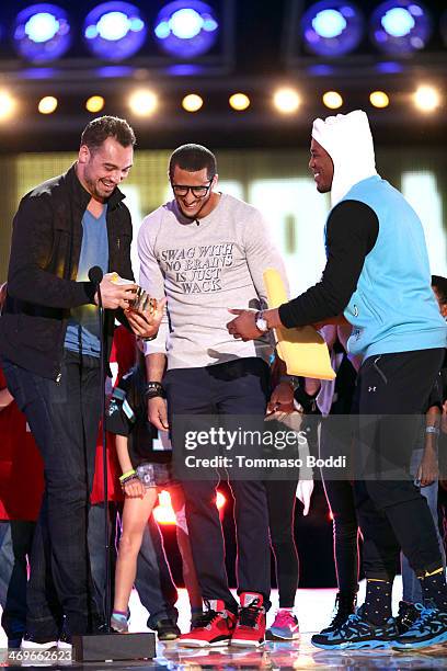 Player Joseph Fauria of the Detroit Lions accepts the Dance Machine award from co-hosts Colin Kaepernick and Cam Newton onstage during the 4th Annual...