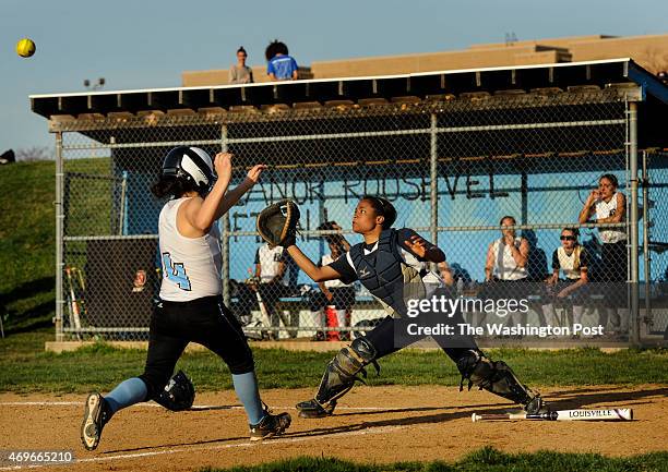 Bowie catcher Jabria Washington waits for the ball before she can get out Eleanor Roosevelt's Maria Ruiz at the plate during the game at Eleanor...