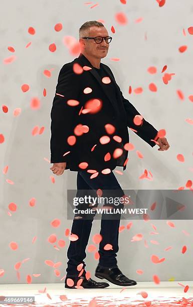 Australian designer Jason Brunsdon acknowledges the applause after a parade of his garments at Fashion Week Australia in Sydney on April 14, 2015....