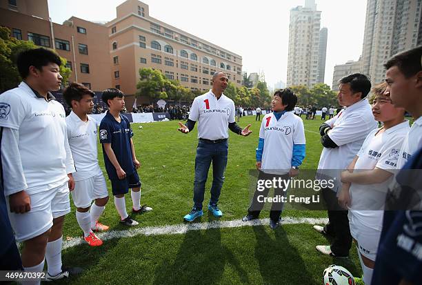 Laureus World Sports Ambassador Ruud Gullit speaks with Former footballer Sun Wen of China during a Laureus Shanghai Football Campus Tour prior to...