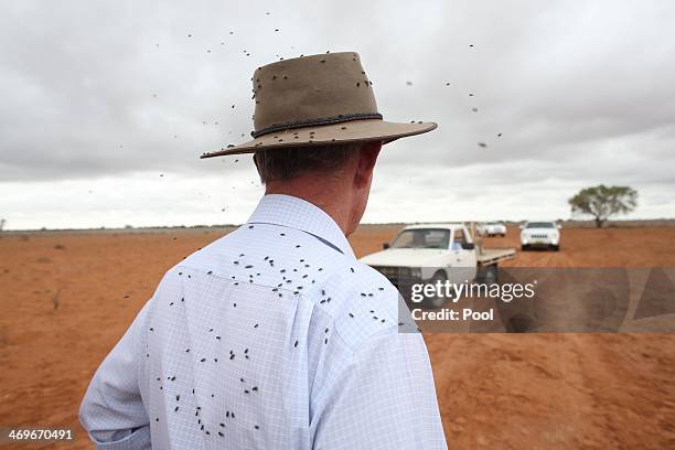 Local MP Mark Coulton awaits Prime Minister Tony Abbott on arrival in the ute of graziers Phillip and Di Ridge of "Jandra" as part of a drought tour...