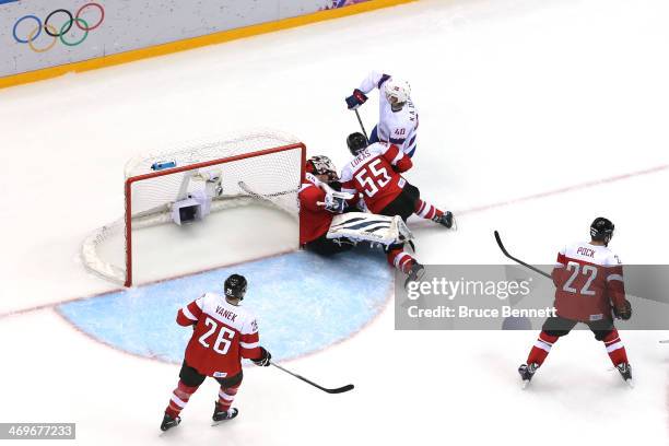 Mathias Lange of Austria collides with teammate Robert Lukas at the net against Ken Andre Olimb of Norway during the Men's Ice Hockey Preliminary...