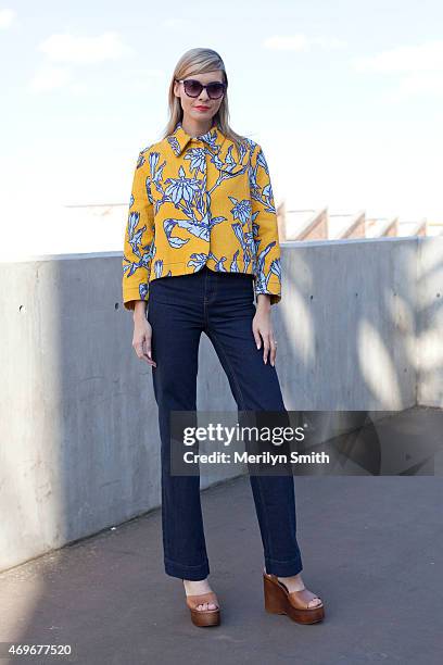 Fashion Blogger Dasha Gold wears a Karen walker top, Lee jeans, Topshop shoes and Dolce and Gabbana sunglasses at Mercedes-Benz Fashion Week...