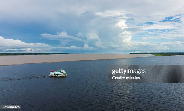 meeting of waters rio negro meets solimões and forms amazon - solimões river stock pictures, royalty-free photos & images