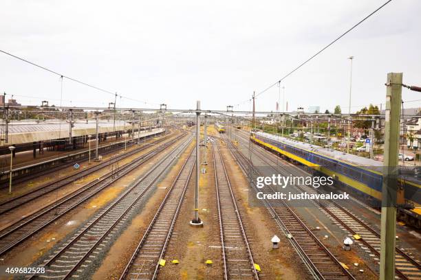 tracks and trains at station maastricht centrale - maastricht stockfoto's en -beelden