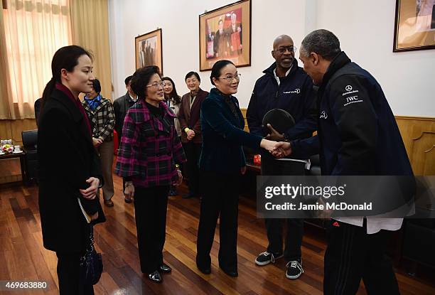Zhao Wen, Vice Mayor of Shanghai shakes the hand of Laureus World Sports Academy member Daley Thompson during a Laureus Shanghai Football Campus Tour...