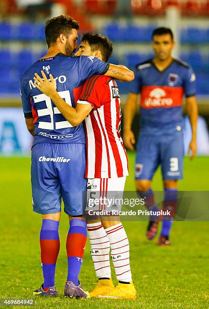 Ernesto Goñi of Tigre hugs Ezequiel Cerutti of Estudiantes after a match between Tigre and Estudiantes as part of 9th round of Torneo Primera...