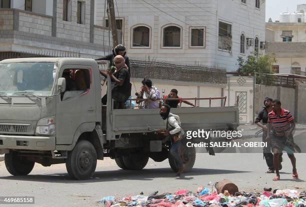 Armed Yemeni members of the southern separatist movement run during reported clashes with Huthi rebels in the port city of Aden's Dar Saad suburb, on...