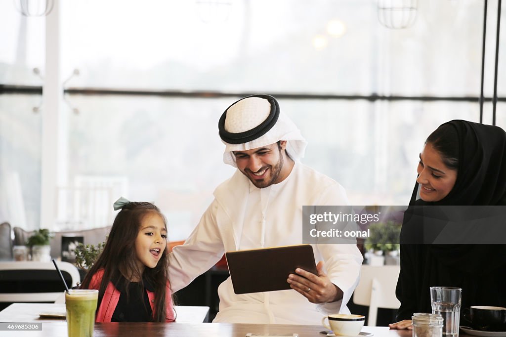 Arabian family enjoying leisure time in a cafe