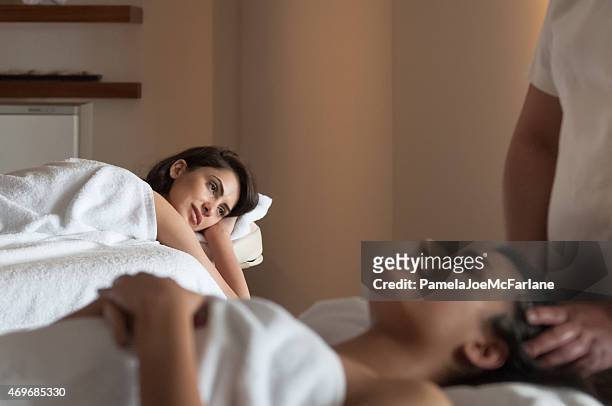 two middle eastern girlfriends wrapped in towels enjoying spa treatments - spa treatment stock pictures, royalty-free photos & images