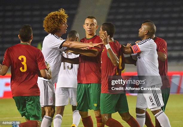 Stiven Tapiero of America de Cali and Gabriel Fuentes of Barranquilla FC argue while teammates try to stop them during a match between Barranquilla...