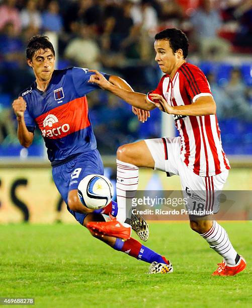 Martin Galmarini of Tigre fights for the ball with Leonardo Jara of Estudiantes during a match between Tigre and Estudiantes as part of 10th round of...