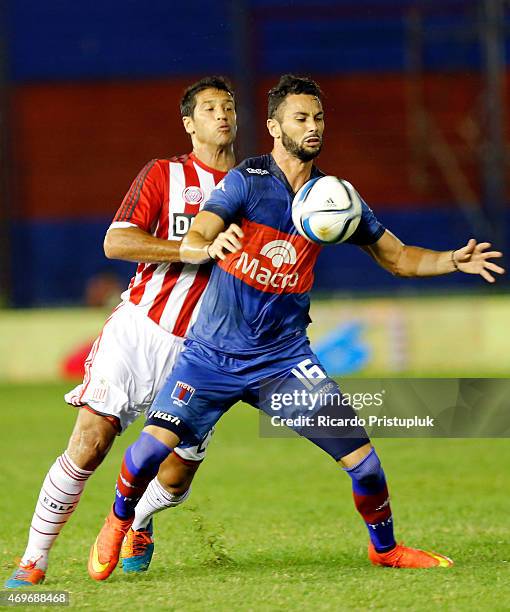 Marcelo Larrondo of Tigre and Sebastian Dominguez of Estudiantes de La Plata fight for the ball during a match between Tigre and Estudiantes as part...