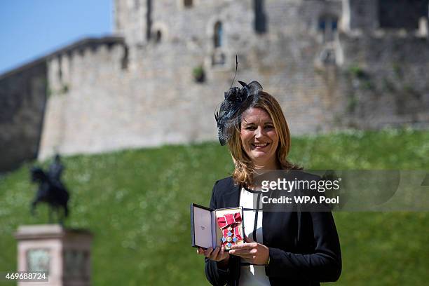 England women's cricket captain Charlotte Edwards holding her Commander of the British Empire , after it was awarded to her by the Queen at an...