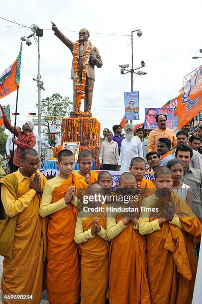 Buddhist monks praying near the idol of Dr BR Ambedkar during a function to pay tribute to him on his birth anniversary on April 14, 2015 in Bhopal,...