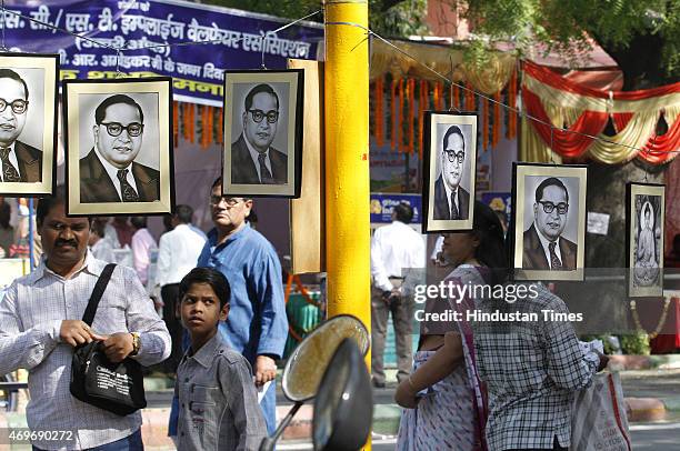 People purchasing portrait of Dr BR Ambedkar after paying tributes on his birth anniversary at Parliament Street on April 14, 2015 in New Delhi,...