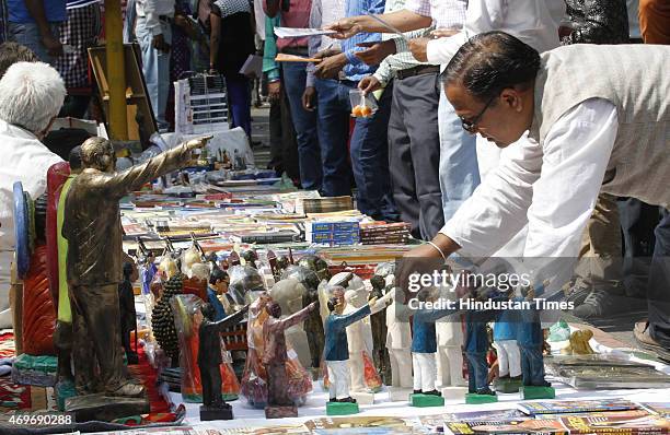 People purchasing portraits and statues of Dr BR Ambedkar after paying tributes on his birth anniversary at Parliament Street on April 14, 2015 in...