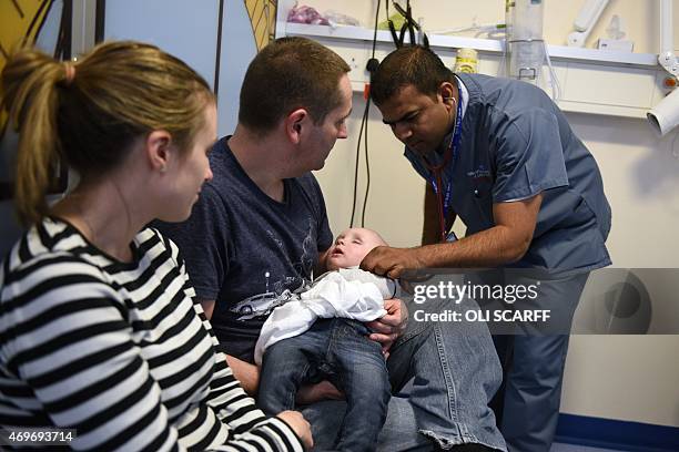 Doctor attends to a young patient in the specialist Children's Accident and Emergency department of the 'Royal Albert Edward Infirmary' in Wigan,...