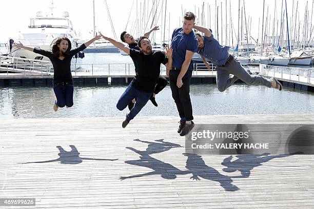 Cast jumps during a photocall for the serie "Screen Australia" during the MIPTV , on April 14, 2015 in Cannes, on the French Riviera. AFP PHOTO /...