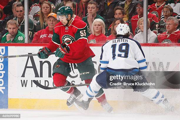 Jim Slater of the Winnipeg Jets defends Mathew Dumba of the Minnesota Wild during the game on April 6, 2015 at the Xcel Energy Center in St. Paul,...