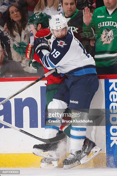 Jim Slater of the Winnipeg Jets and Ryan Suter of the Minnesota Wild collide during the game on April 6, 2015 at the Xcel Energy Center in St. Paul,...