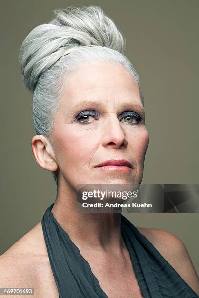 mature woman with grey haired bun, portrait. - hair bun how to stock pictures, royalty-free photos & images