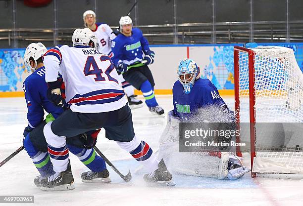 David Backes of the United States shoots and scores against Luka Gracnar of Slovenia in the third period during the Men's Ice Hockey Preliminary...