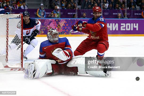 Semyon Varlamov of Russia makes a save against Slovakia during the Men's Ice Hockey Preliminary Round Group A game on day nine of the Sochi 2014...